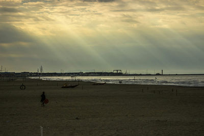 View of calm beach at sunset