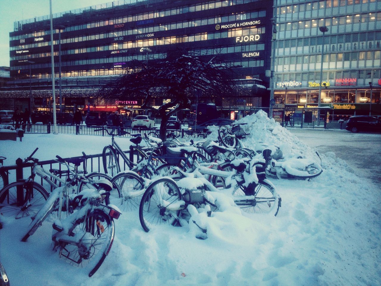 building exterior, architecture, built structure, city, winter, snow, cold temperature, street, season, building, reflection, land vehicle, city life, weather, car, transportation, city street, outdoors, illuminated, street light