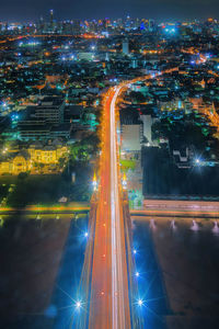 Aerial view of illuminated city buildings at night