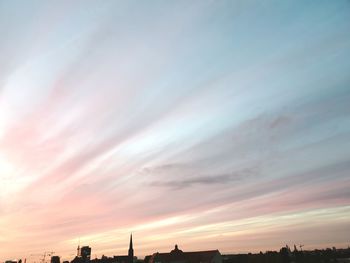 Low angle view of silhouette buildings against sky during sunset