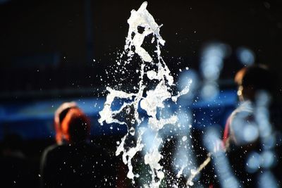 Close-up of man splashing water in winter