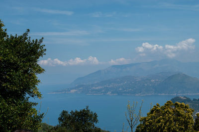 Scenic view of sea and mountains against sky