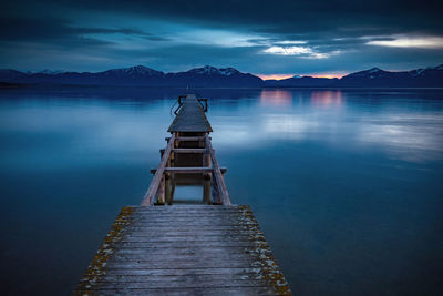 Pier over lake against sky