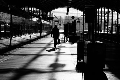 Silhouette man walking in bus