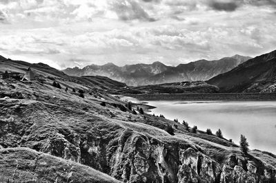 Scenic view of lake and mountains against sky