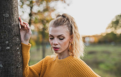 Portrait of young woman in park