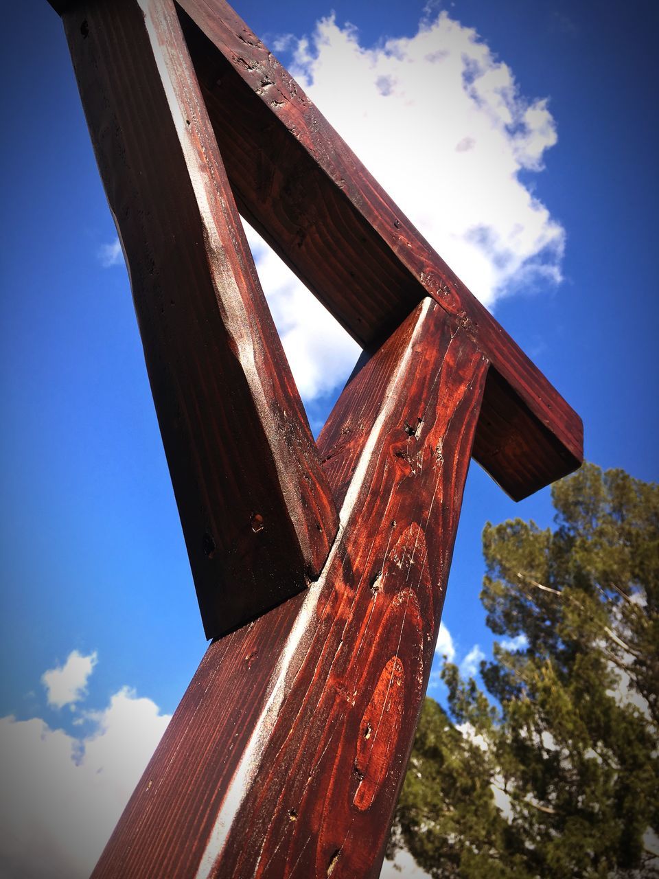 sky, wood - material, low angle view, nature, day, cloud - sky, no people, metal, outdoors, rusty, architecture, blue, built structure, tree, old, sunlight, security, weathered, wood, brown