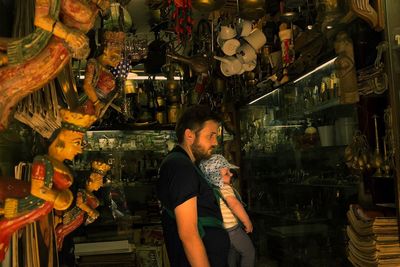 Man with son standing at shop