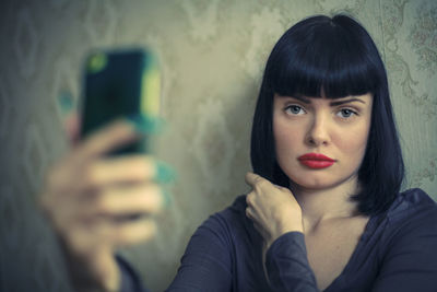 Portrait of young woman using mobile phone