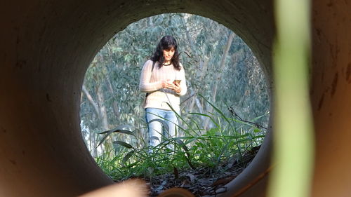 Woman standing against plants