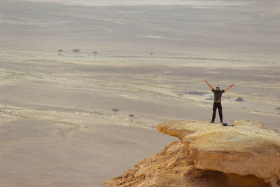 Full length of man standing on rocks