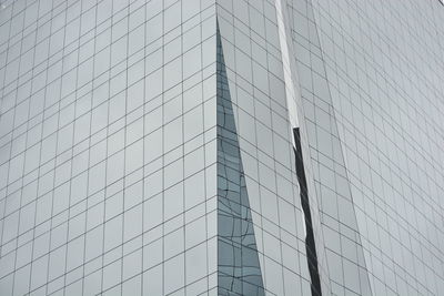 Low angle view of modern glass building in city