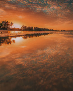 Scenic view of sea against orange sky