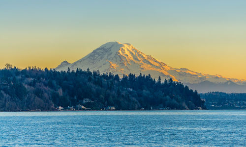 Mount rainier across the puget sound at twilight. photo taken from burien, washington.