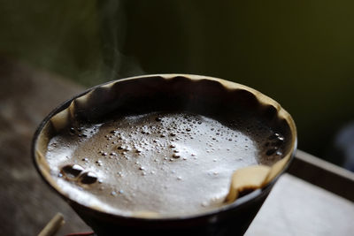 Close-up of coffee being filtered in cup