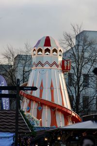 Low angle view of ferris wheel in city