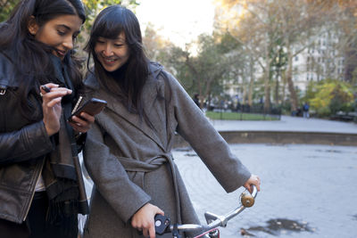 Young women checking their smart phones