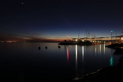 Scenic view of lake against sky at night