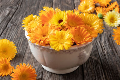 High angle view of yellow flowers on table