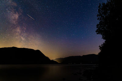 The milky way over ullswater in the english lake district with a meteorite flashing across the sky