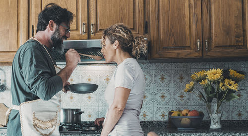 Side view of man preparing food at home