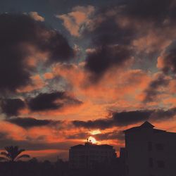 Low angle view of building against cloudy sky