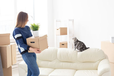 Woman carrying boxes at home