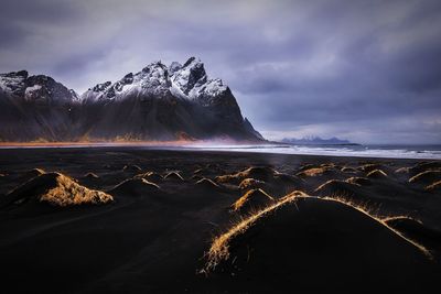 Scenic view of snowcapped mountains and sea against sky