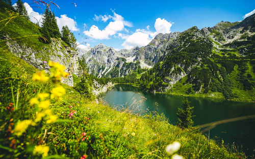 Scenic view of lake and mountains against sky