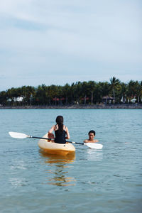 Man kayaking in sea