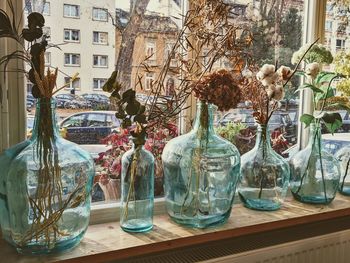 Panoramic shot of glass vase on table against building
