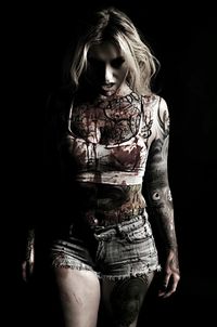 Midsection of woman standing against black background