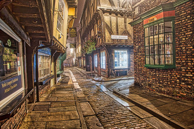 Empty alley amidst buildings in city