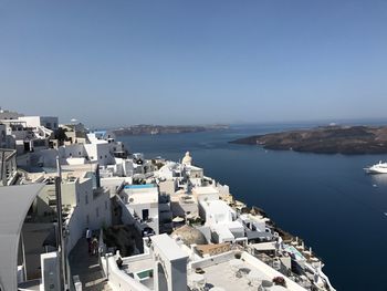 High angle view of town by sea against clear sky