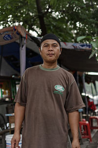 Portrait of mature man standing at market