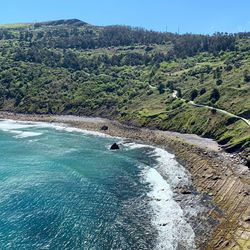 High angle view of sea by mountain