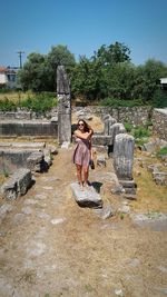 Woman and girl on tree against sky