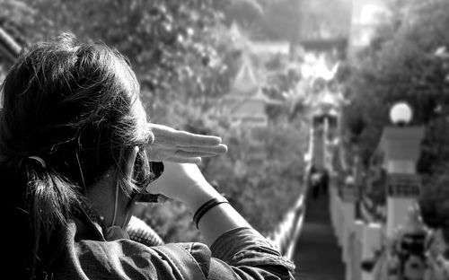 Woman photographing on footbridge