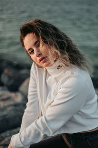 Portrait of woman against water