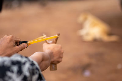 Close-up of man holding cigarette