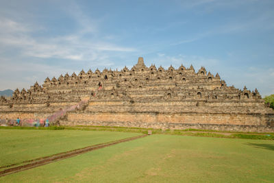 Ruins of temple against cloudy sky