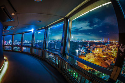 Illuminated cityscape seen through window