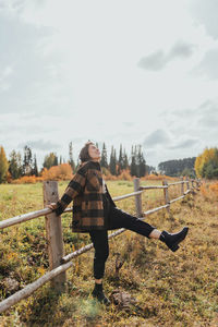 Woman standing on field against sky