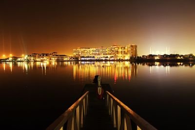 Reflection of illuminated buildings in water at night