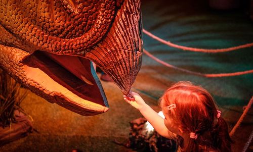 Rear view of woman with arms raised