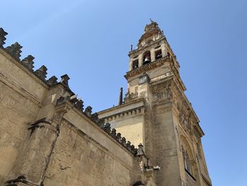 Low angle view of historic building against clear blue sky