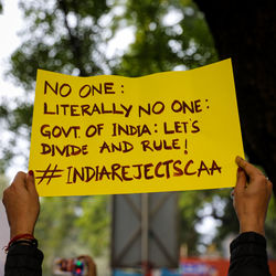 Low section of person holding yellow text