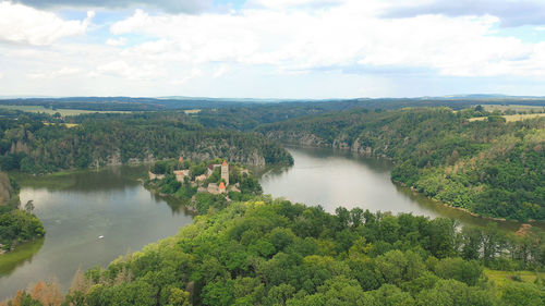 High angle view of river amidst trees against sky