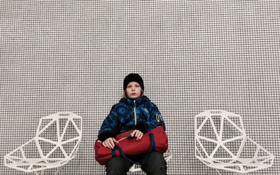 Portrait of boy sitting on floor