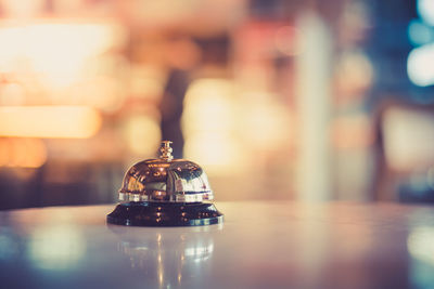 Close-up of illuminated lamp on table